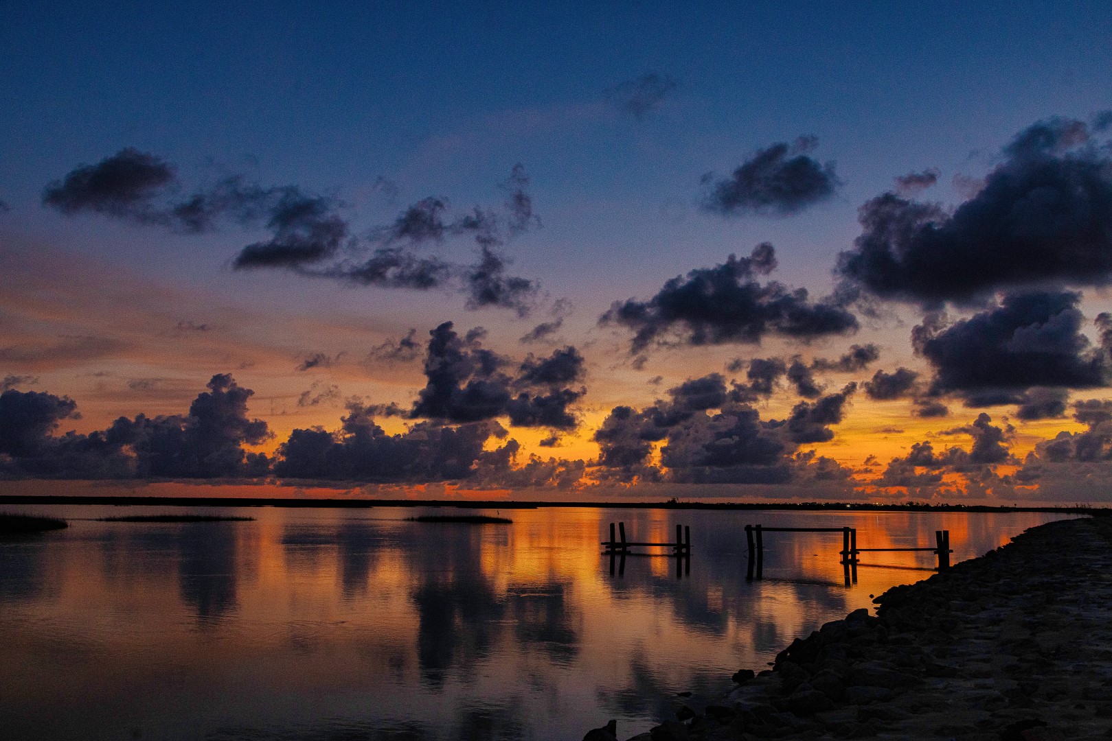 Fine art release over still coastal water